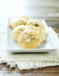 A close up of almond cookies on a white plate