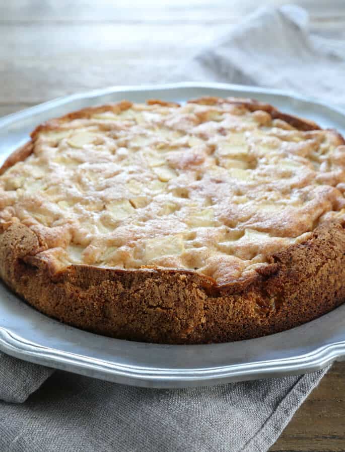 A close up of an apple cake on a silver surface 