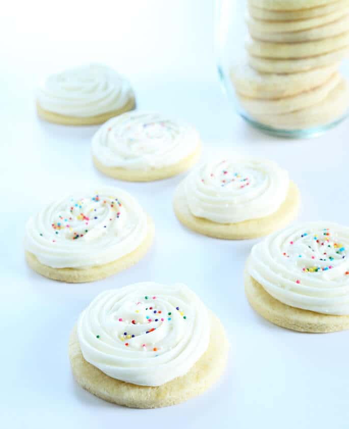 Soft and tender gluten free cream cheese cutout sugar cookies with slightly firm Lofthouse-style frosting. Basically, they're the perfect cookie.