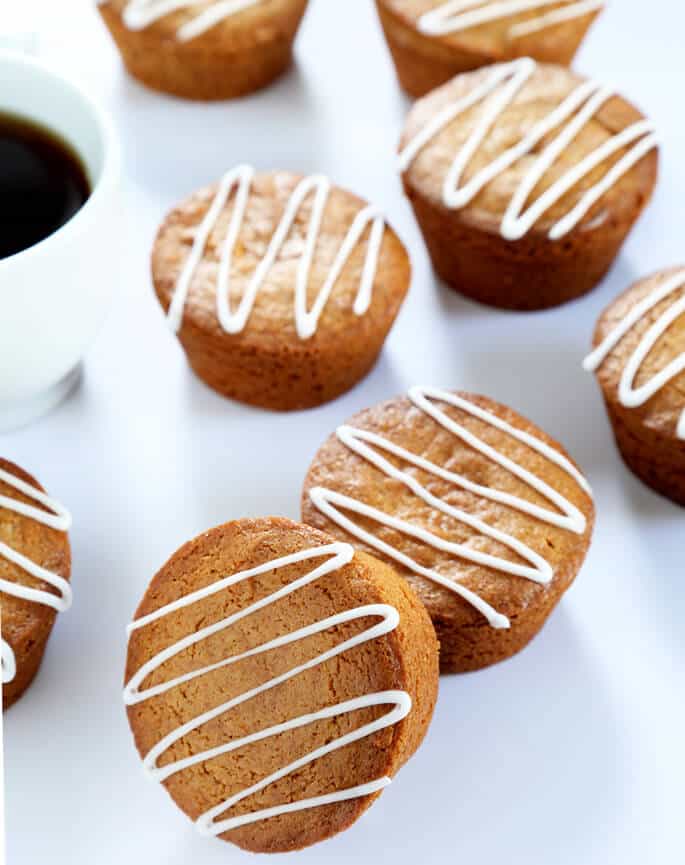 Overhead view of gingerbread muffins with glaze on a white surface 