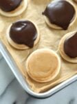 Overhead view of peanut butter "Twix" cookies on parchment paper