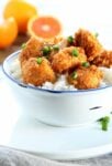 Chinese-style orange chicken with rice in a white bowl