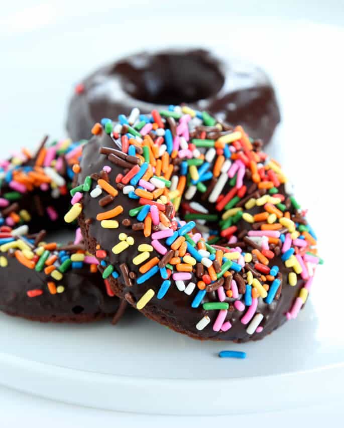 image of three chocolate cake donuts on a plate