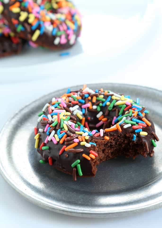 These quick and easy gluten free chocolate cake donuts are the perfect way to satisfy your donut cravings. Make them in a donut pan or a muffin tin. And don't forget the rich chocolate glaze!