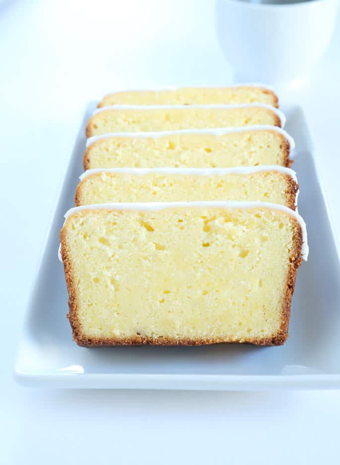 Slices of lemon pound cake on a rectangular serving platter.