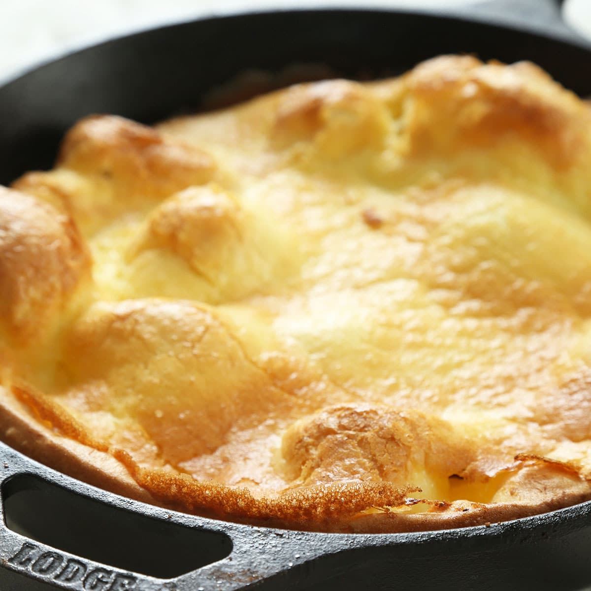 gluten free Dutch baby pancake in black Lodge cast iron skillet