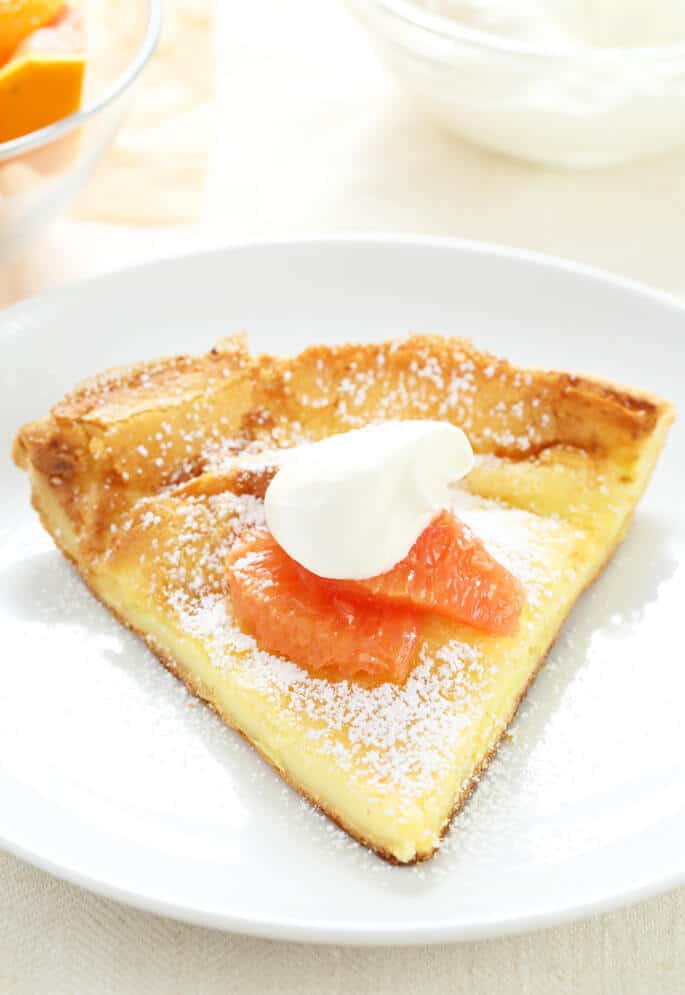 Close up of large pancake style pastry on a white plate