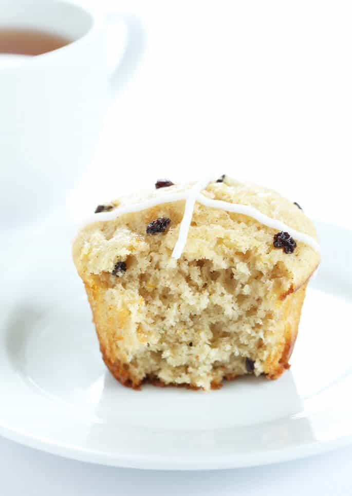 A close up of the inside of a hot cross bun on white plate 