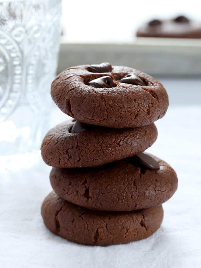 A stack of 4 chocolate flourless peanut butter cookies