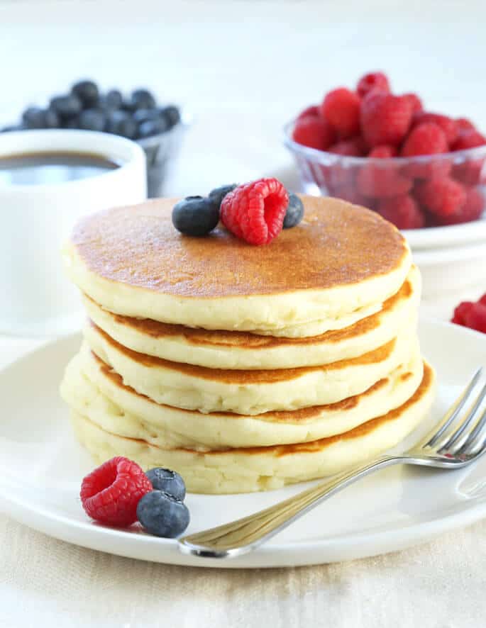 Stack of 5 pancakes on a white plate