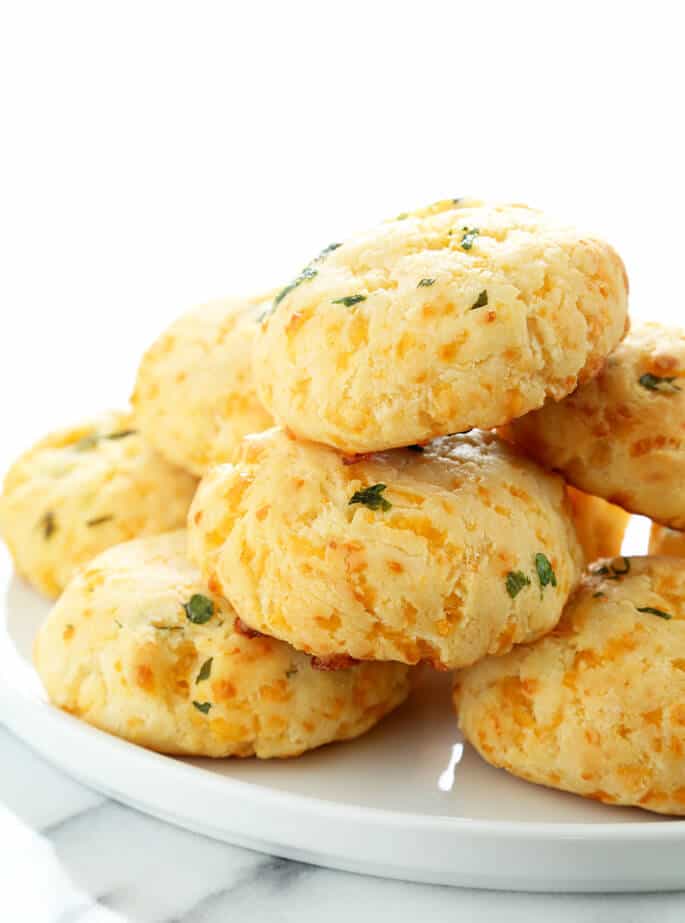 A platter of gluten free cheddar bay biscuits, image from the side.