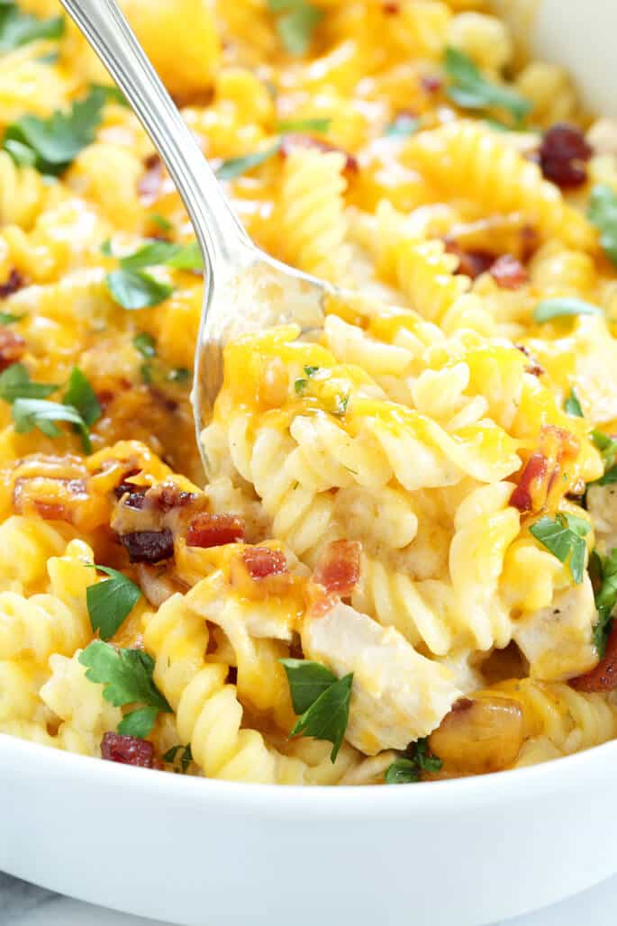 A close up of chicken bacon casserole being scooped