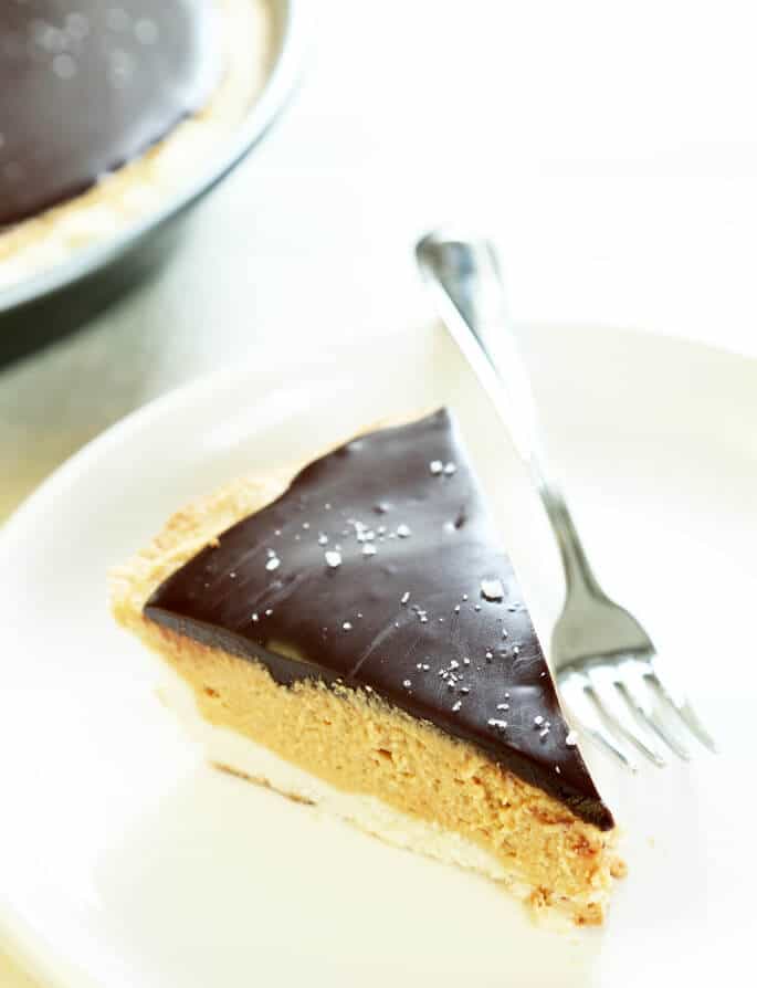 Close up of a slice of peanut butter pie on white plate with fork