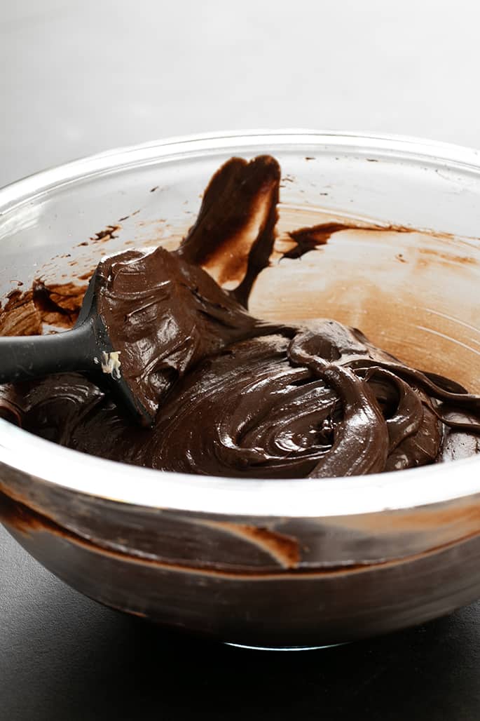 Glossy and rich batter for fudgy flourless brownies, ready to go in the pan.