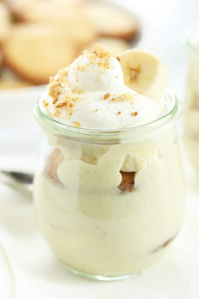 Banana pudding in a jar with whip cream and banana