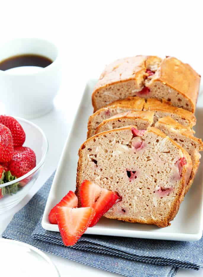 A loaf of strawberry bread on a white plate 