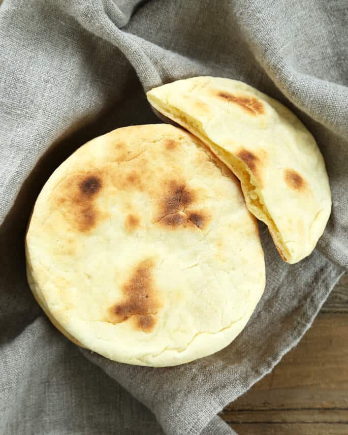 Overhead view of pita bread on a gray towel 