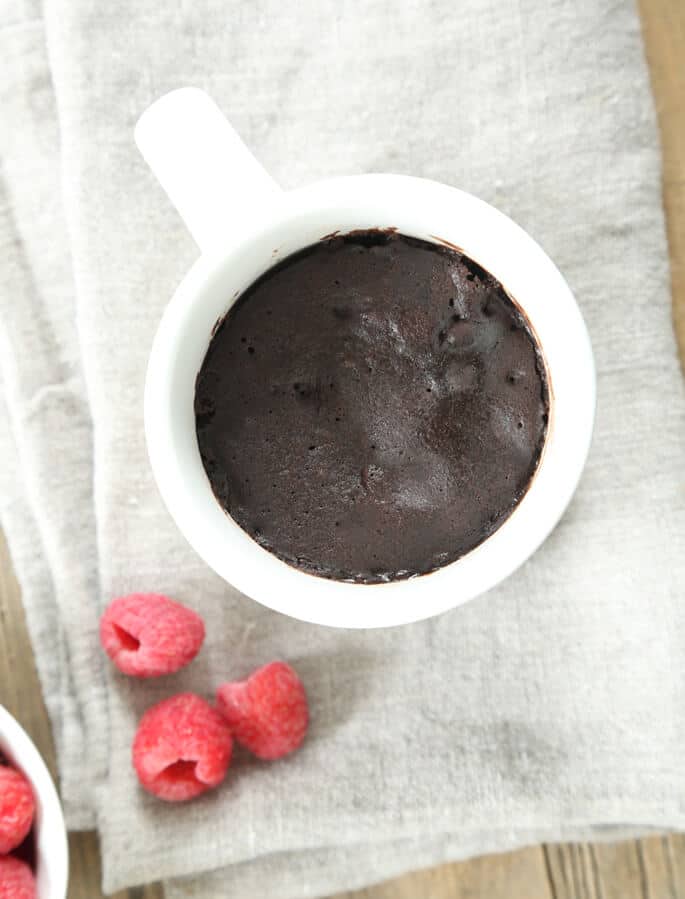 Overhead view of mug cake on gray towel