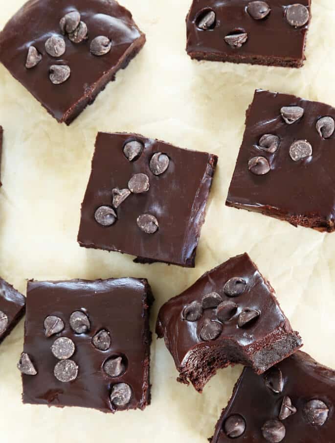 These naturally gluten free flourless brownies are rich and fudgy, with a Paleo option, too. Made simply, with melted chocolate and cocoa powder, and topped with chocolate ganache.