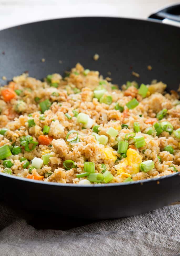 Close up of cauliflower fried rice in a black pan