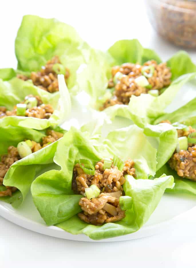 Asian chicken lettuce wraps on a white plate