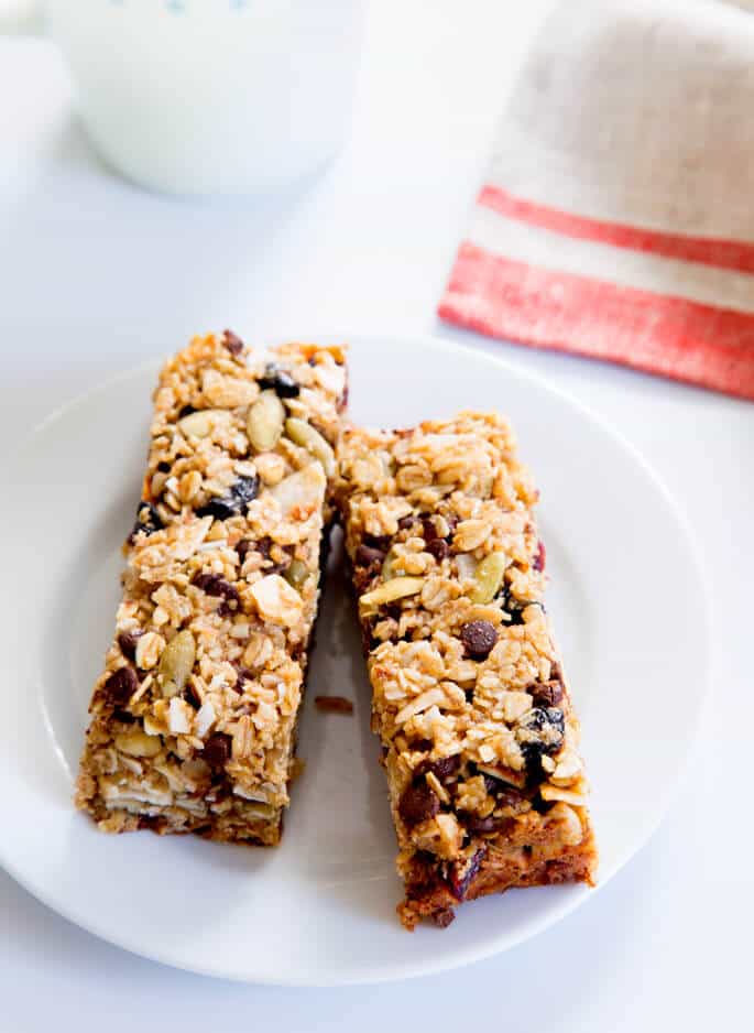 Overhead view of 2 granola bars on a white plate