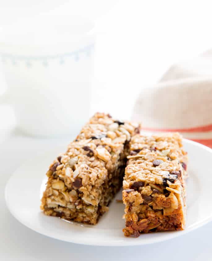 A close up of 2 granola bars on a white plate