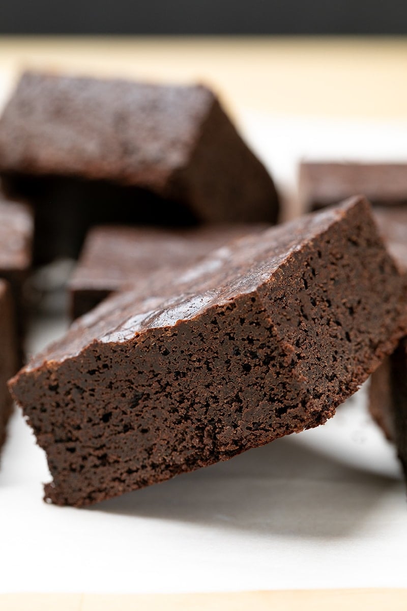 Almond flour brownie on its side on white paper