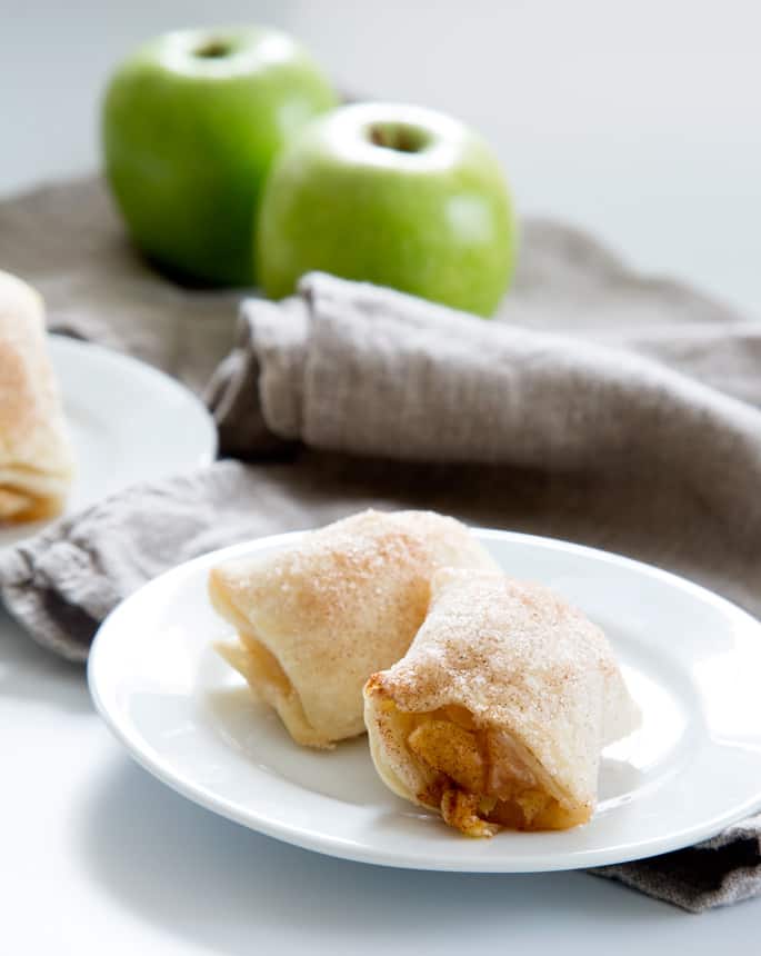 A close up of 2 apple dumplings on a white plate