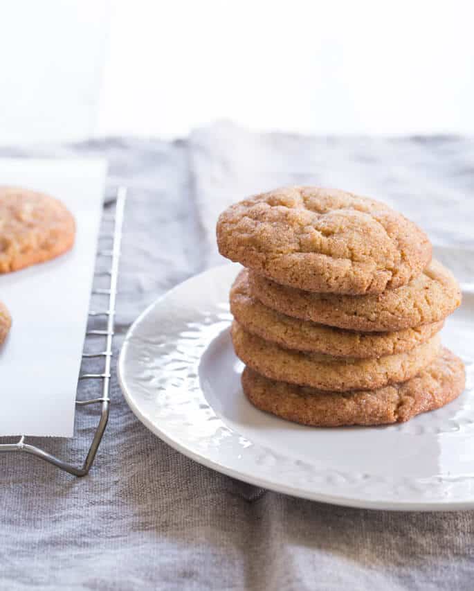 A close up of a stack of 5 snickerdoodle cookies on a white plate