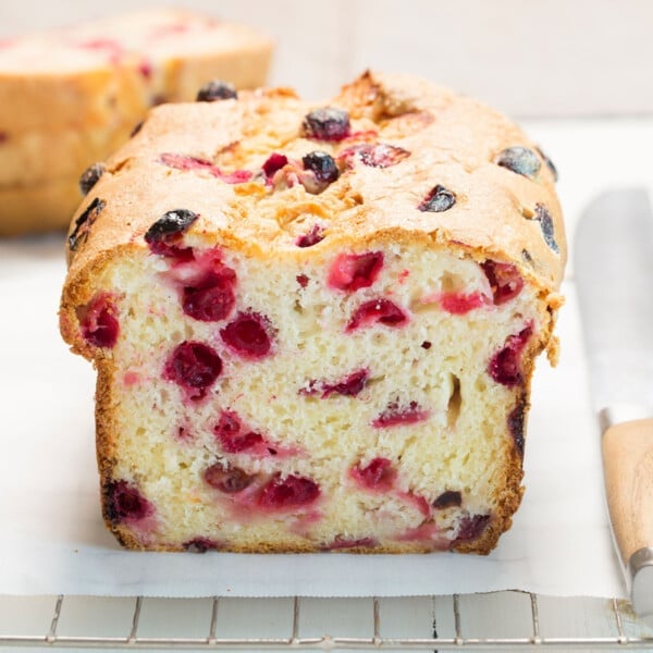 gluten free cranberry bread sliced in half on white paper