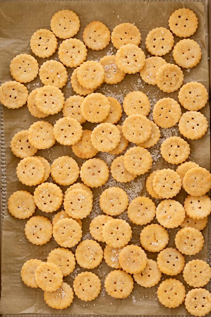 Baked Ritz crackers piled on baking tray overhead image