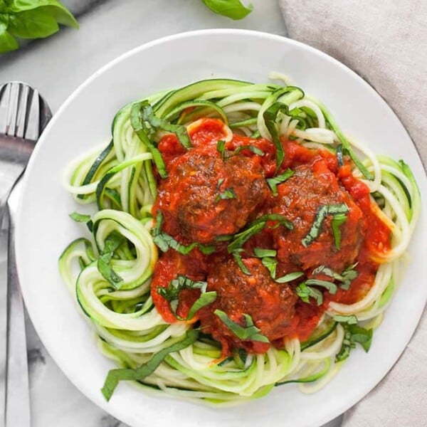 These paleo meatballs are tender, flavorful, and super satisfying on top of a bed of spiralized zucchini noodles!