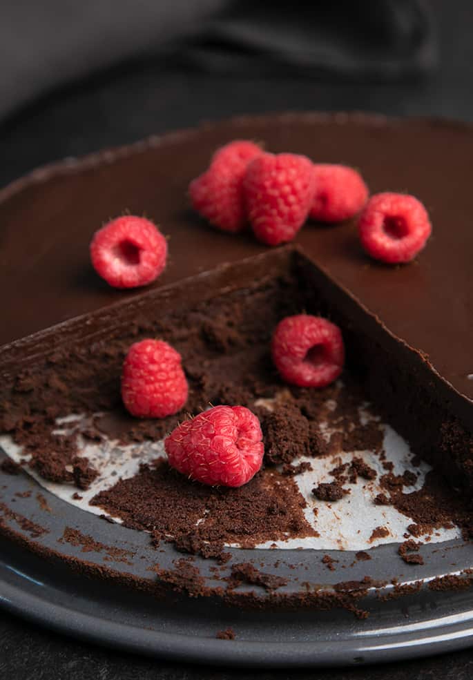 Flourless chocolate cake with raspberries with 2 slices taken