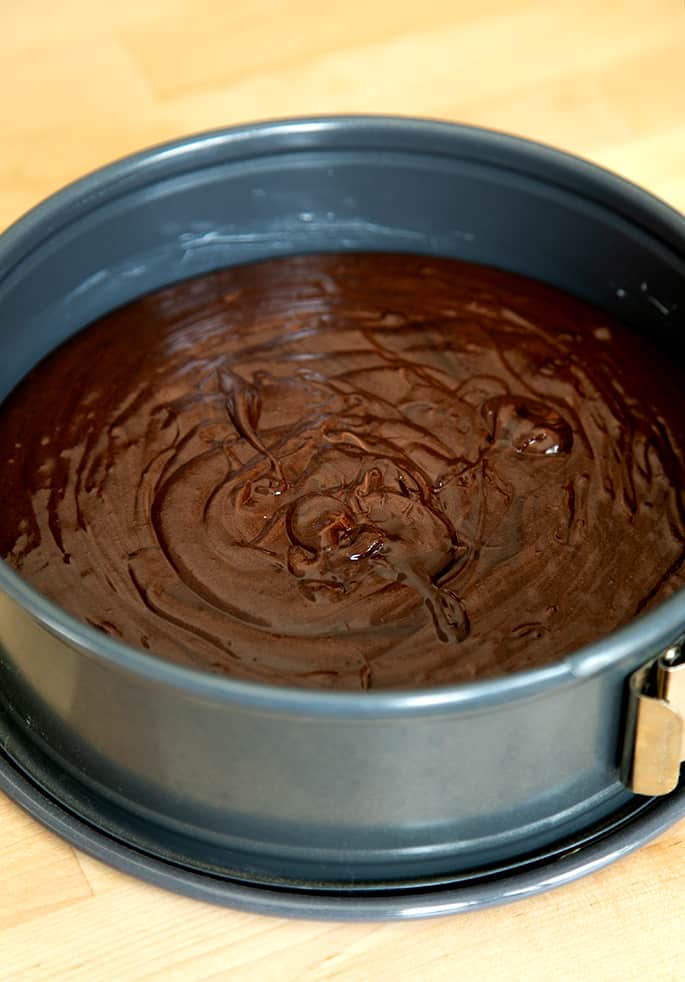 Raw flourless chocolate cake batter in springform pan