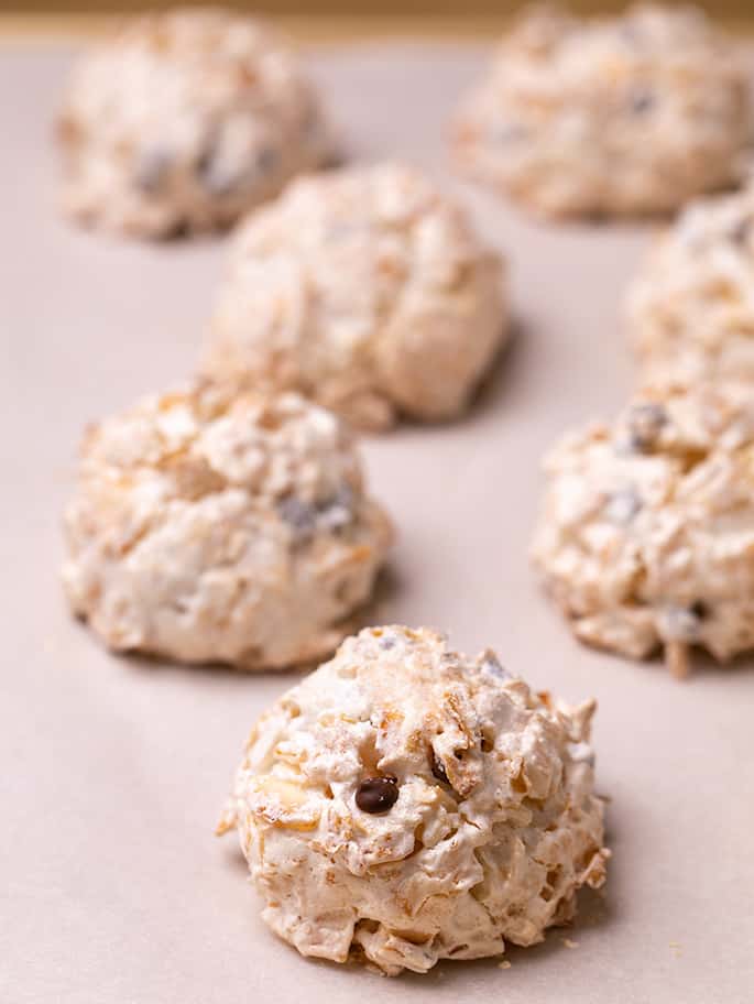 Coconut macaroons baked on white paper on tray