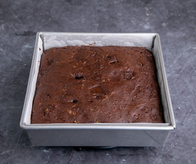 Baked chocolate zucchini cake in square baking pan