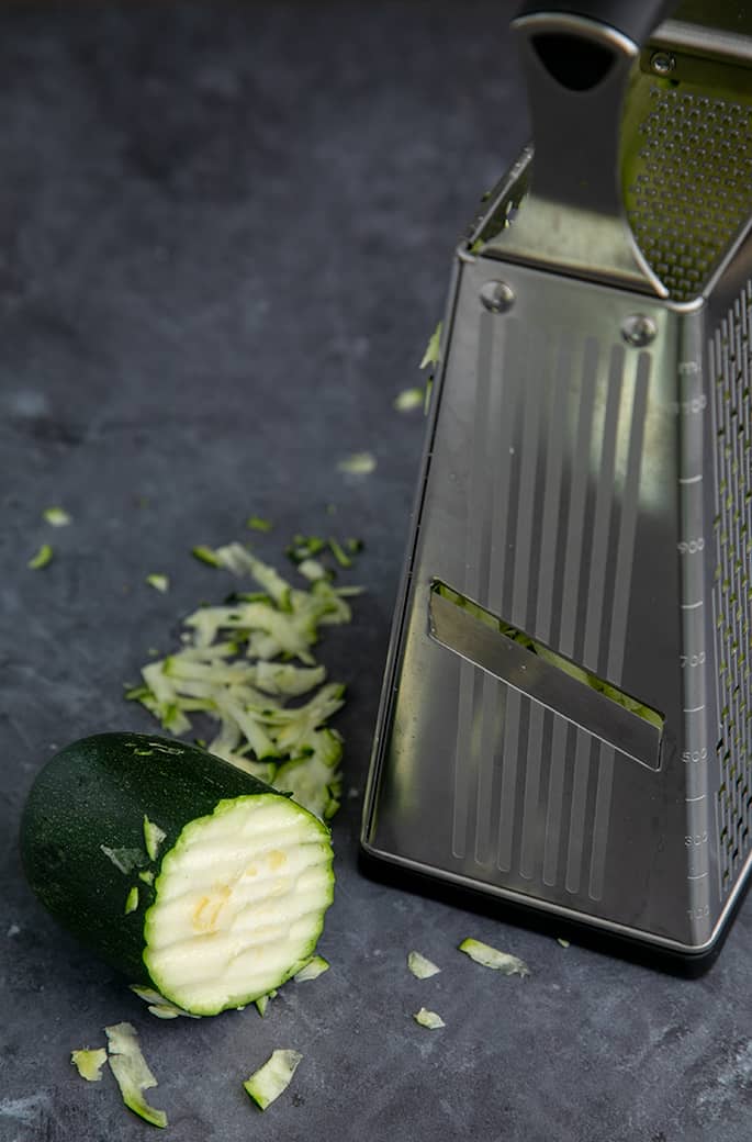 Box grater with partially grated zucchini