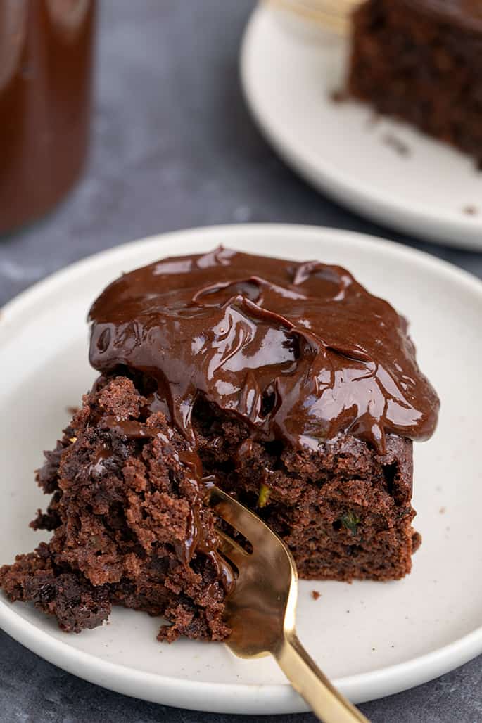 Fork resting in slice of chocolate cake