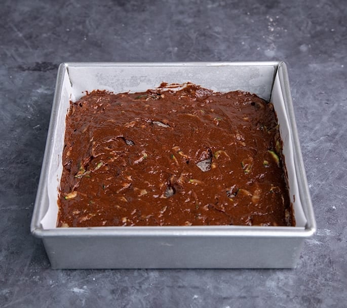 Raw chocolate zucchini cake batter in square baking pan