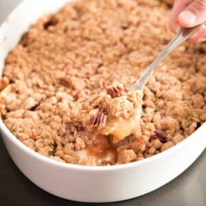 gluten free apple crumble in large casserole dish with serving spoon