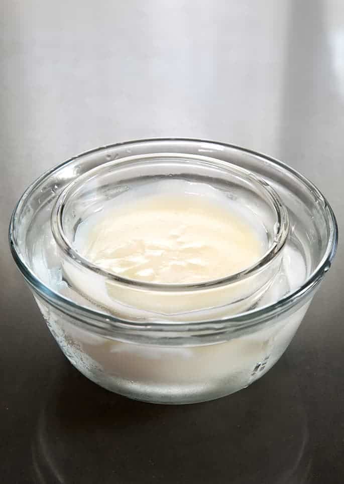 A sweet roux in a small bowl cooling over a larger bowl of ice water