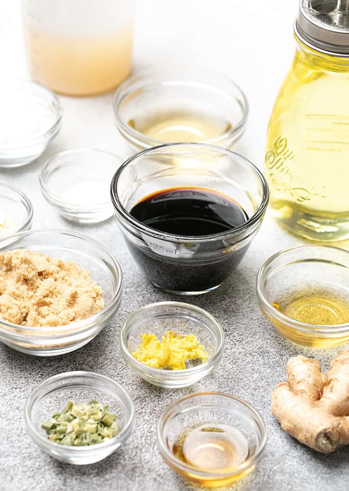 Different sizes of small glass bowls with ingredients for lomein sauce