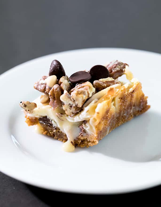 This recipe for 7 Layer Bars is endlessly customizable, made easily with or without coconut, gluten free graham cracker crumbs, and even easily made dairy free!