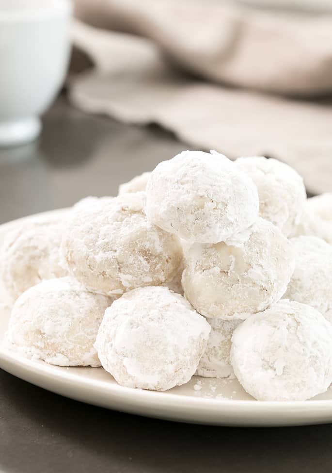 These gluten free snowball cookies, also known as Russian tea cakes and Mexican wedding cookies are super tender butter cookies, made with chopped nuts and always covered in powdered sugar.