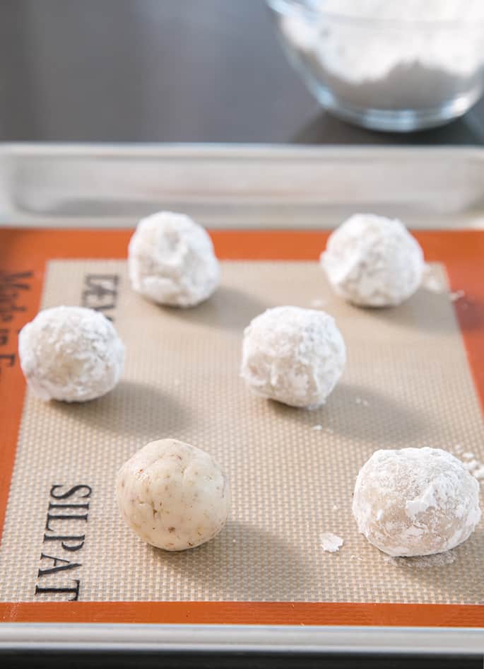 These gluten free snowball cookies, also known as Russian tea cakes and Mexican wedding cookies are super tender butter cookies, made with chopped nuts and always covered in powdered sugar.