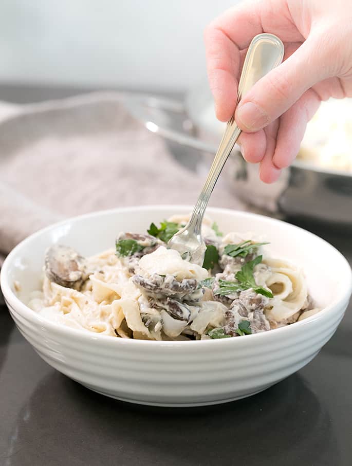 This rich, creamy vegan alfredo sauce is made with cashews and coconut milk, and no nutritional yeast. It even reheats beautifully.