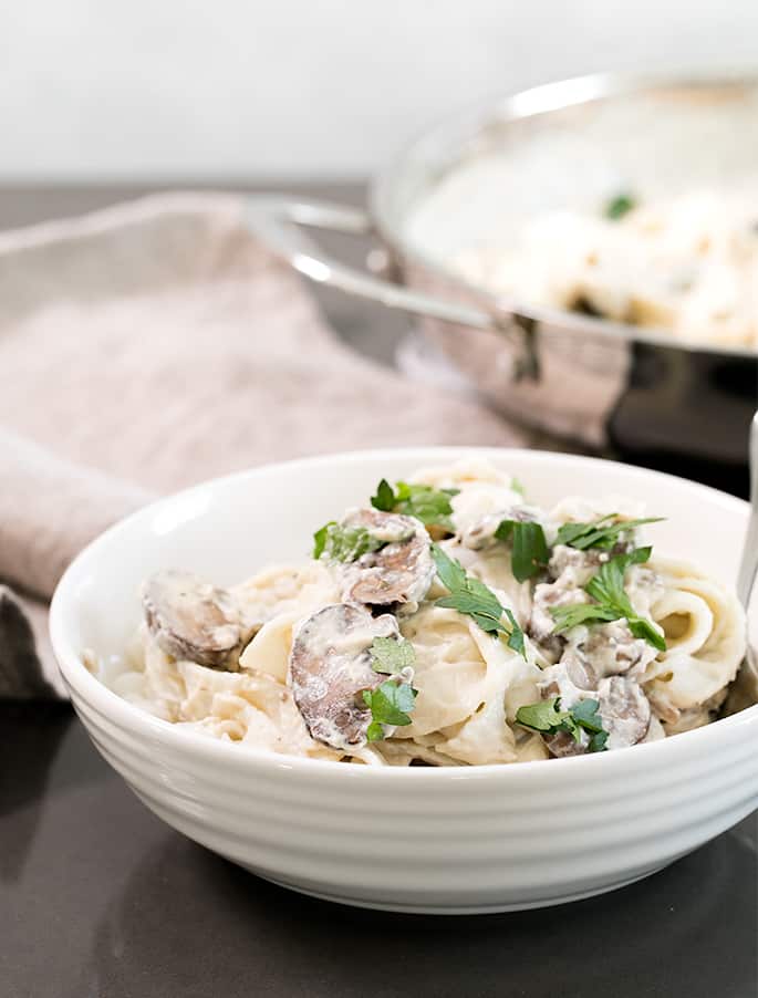 This rich, creamy vegan alfredo sauce is made with cashews and coconut milk, and no nutritional yeast. It even reheats beautifully.