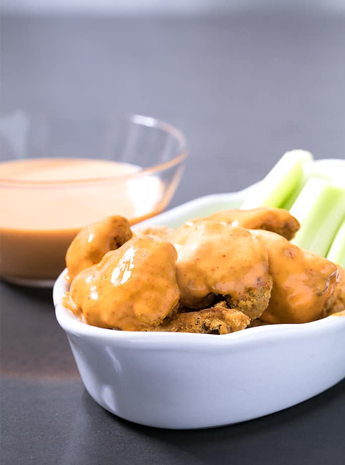 This easy recipe for buffalo cauliflower bites is made in the Air Fryer for a low-calorie, Paleo-friendly appetizer or side dish. Naturally gluten free and dairy-free, too!