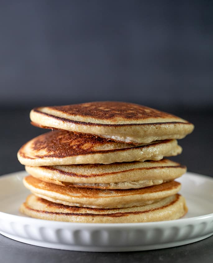 Protein pancakes in a stack on a small plate